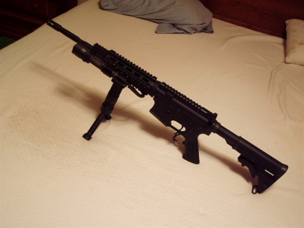 CMMG- MK4- AR-22. HAS A 16" BARREL WITH A FLASH HIDER/BAYO LUG / 6 POSITION STOCK / SURE FIRE TAC LITE / REMOVEABLE HANDLE / QUAD RAILS / 4 SIDED FOREARM RAIL  / ONE 25 ROUND MAGAZINE, FRONT STABILIZE